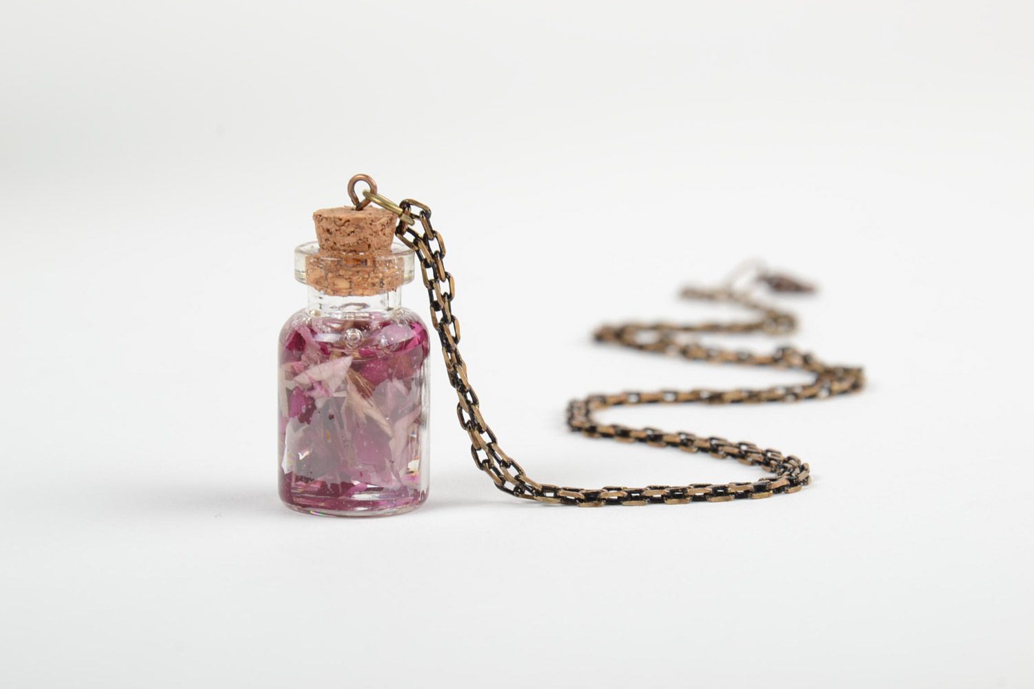 Handmade epoxy resin neck pendant with real flowers inside in the shape of transparent vial photo 4