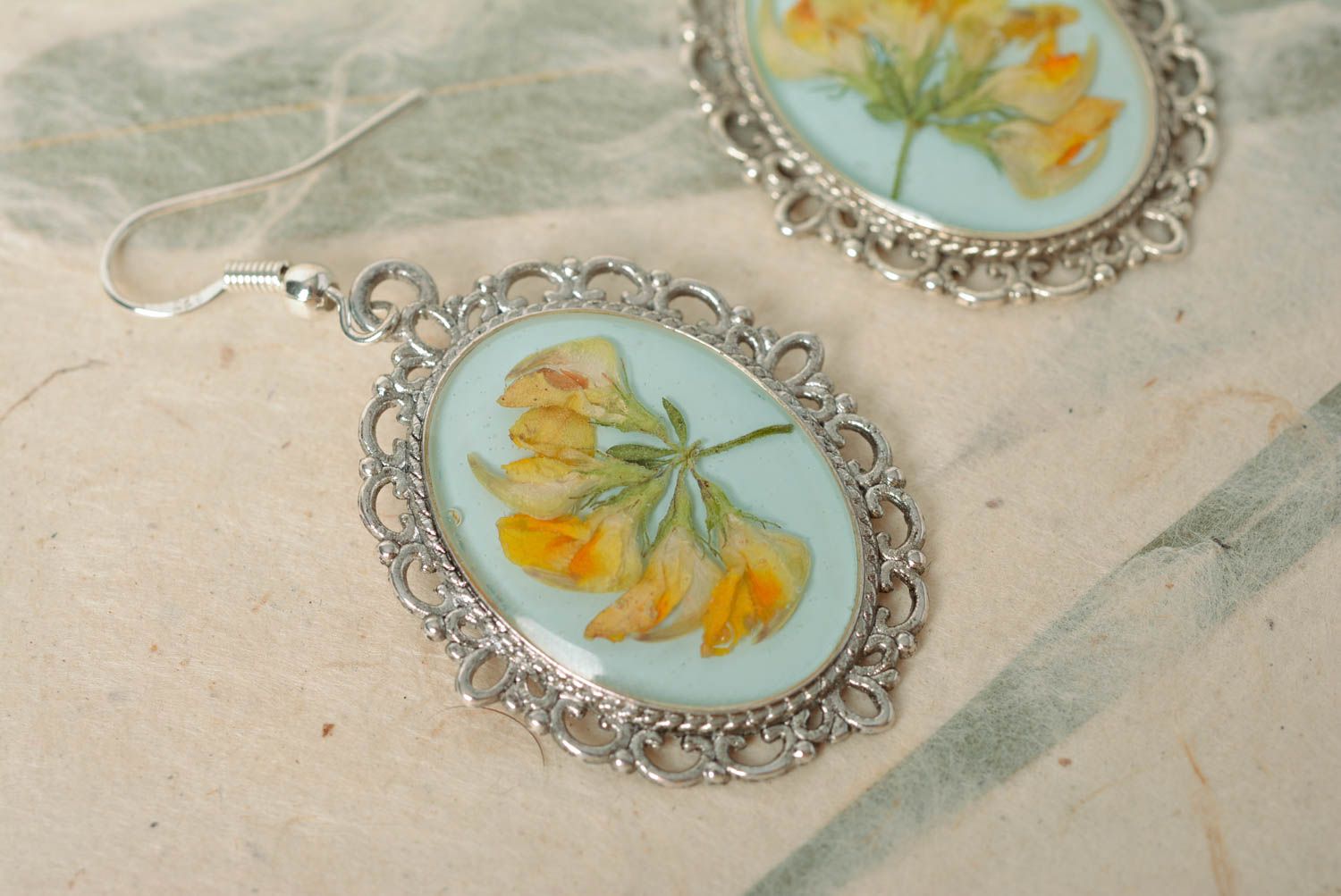 Handmade oval dangle earrings with metal basis and dried flowers in epoxy resin photo 4