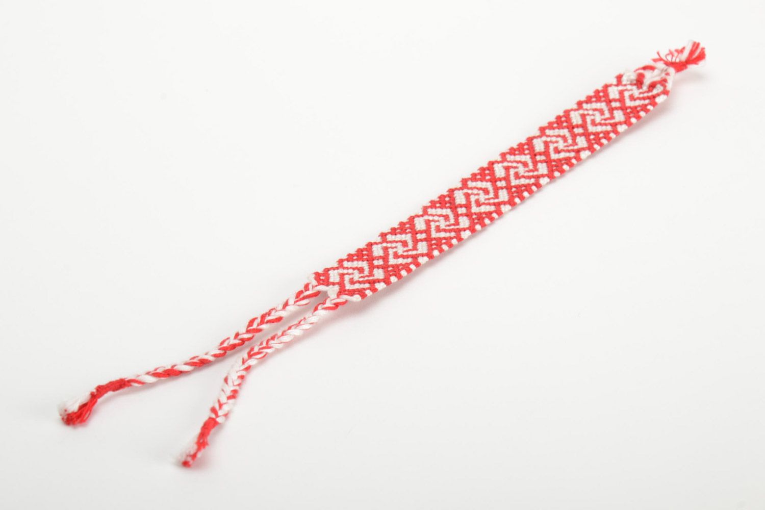 Handmade ethnic friendship wrist bracelet woven of red and white threads photo 2