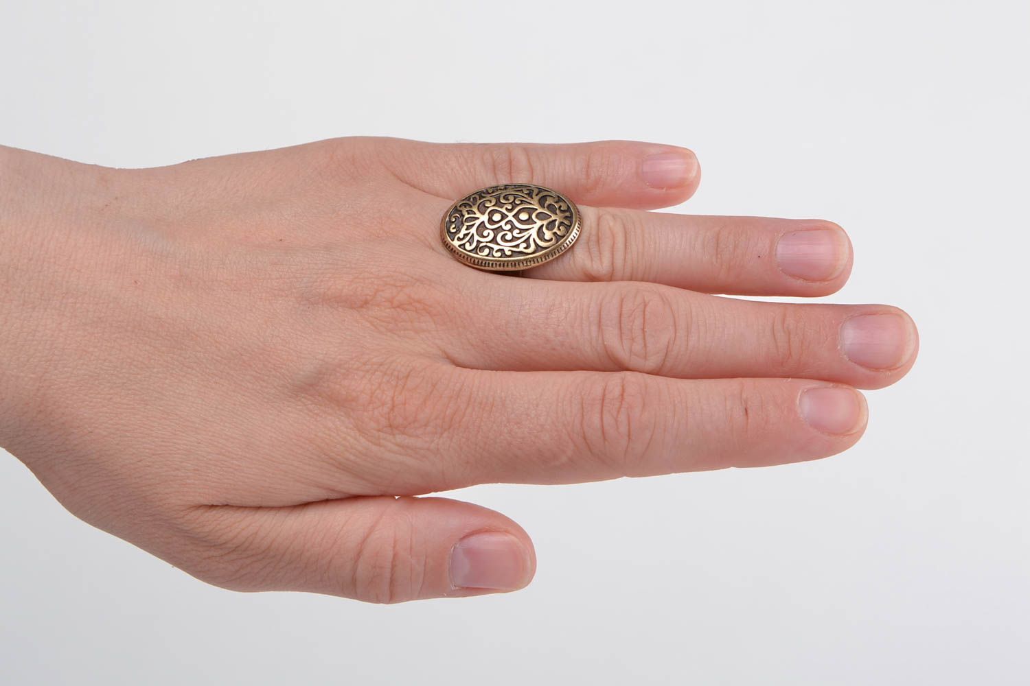 Handmade oval jewelry ring cast of metal alloy with ornament in ethnic style photo 1