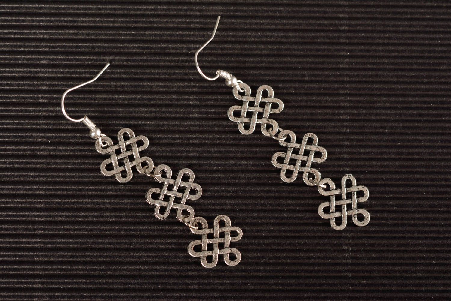Handmade long designer metal dangle earrings of silver color in ethnic style photo 1