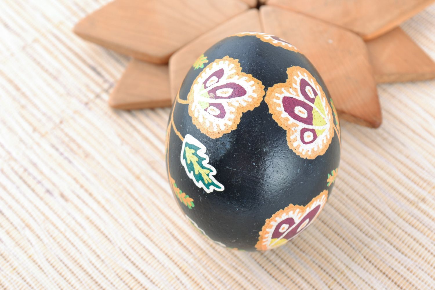 Handmade painted dark chicken Easter egg with flower pattern photo 1