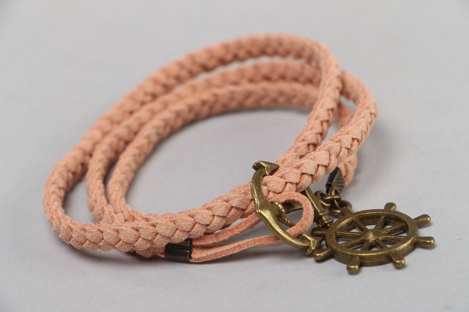 Handmade friendship bracelet woven of beige faux suede cord with steering wheel  photo 1