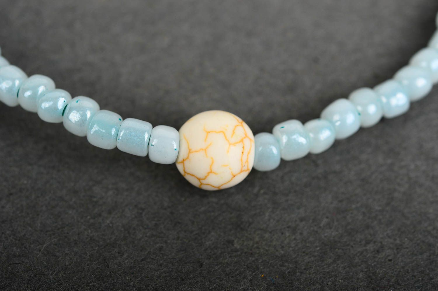 Handmade pale blue beaded stretchy wrist bracelet with beige ball shape centerpiece photo 4