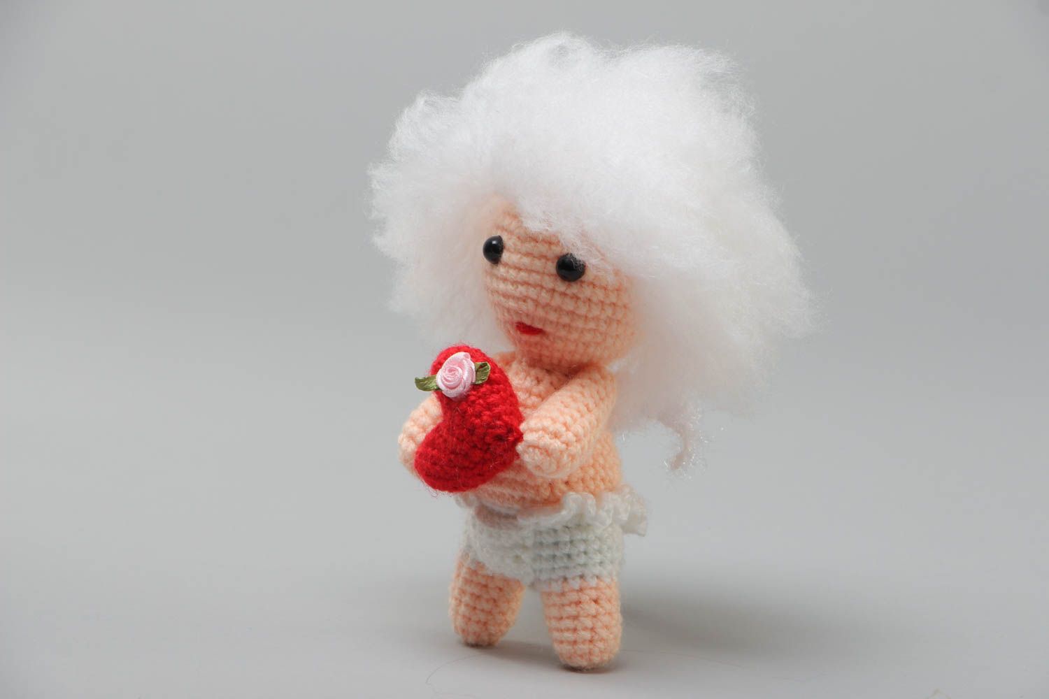 Handmade soft crochet toy in the shape of cute curly cupid with red heart photo 2