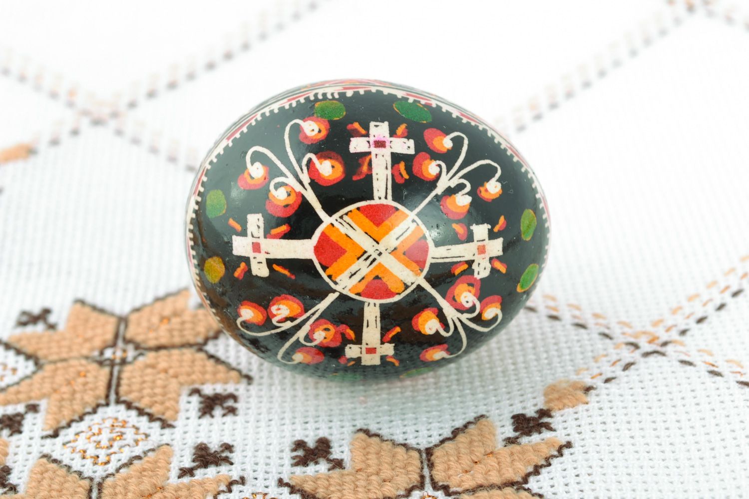 Handmade Easter egg with cross-shaped ornament painted with wax and aniline dyes photo 1