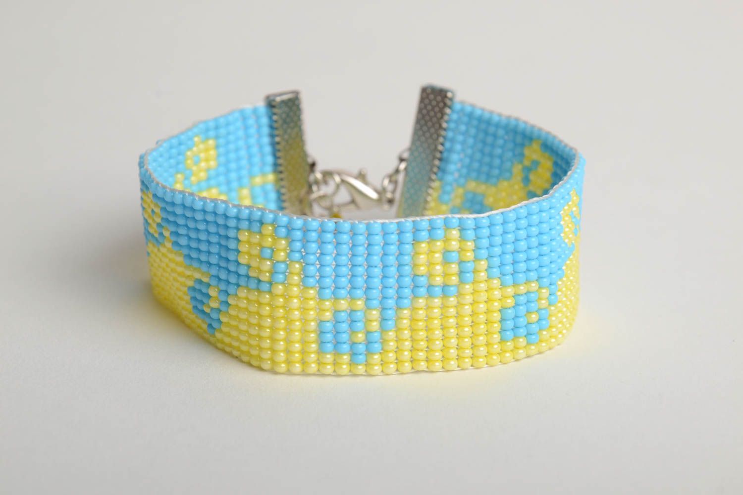 Handmade wide flat bead woven wrist bracelet with blue and yellow ornament photo 3
