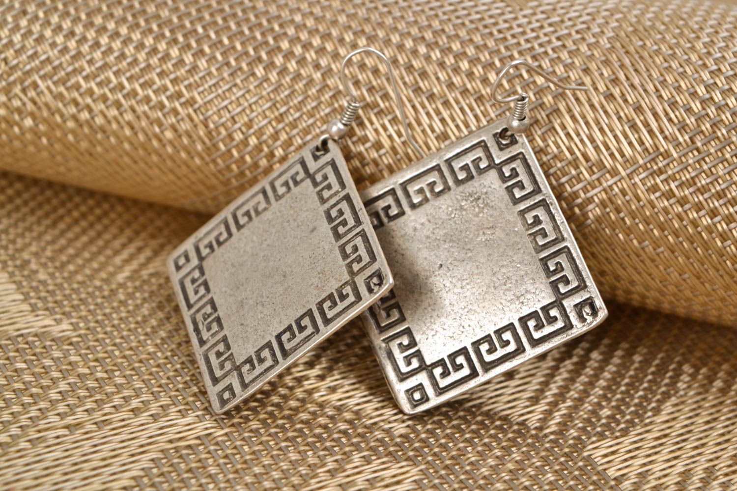 Metal earrings in the shape of rhombus photo 1