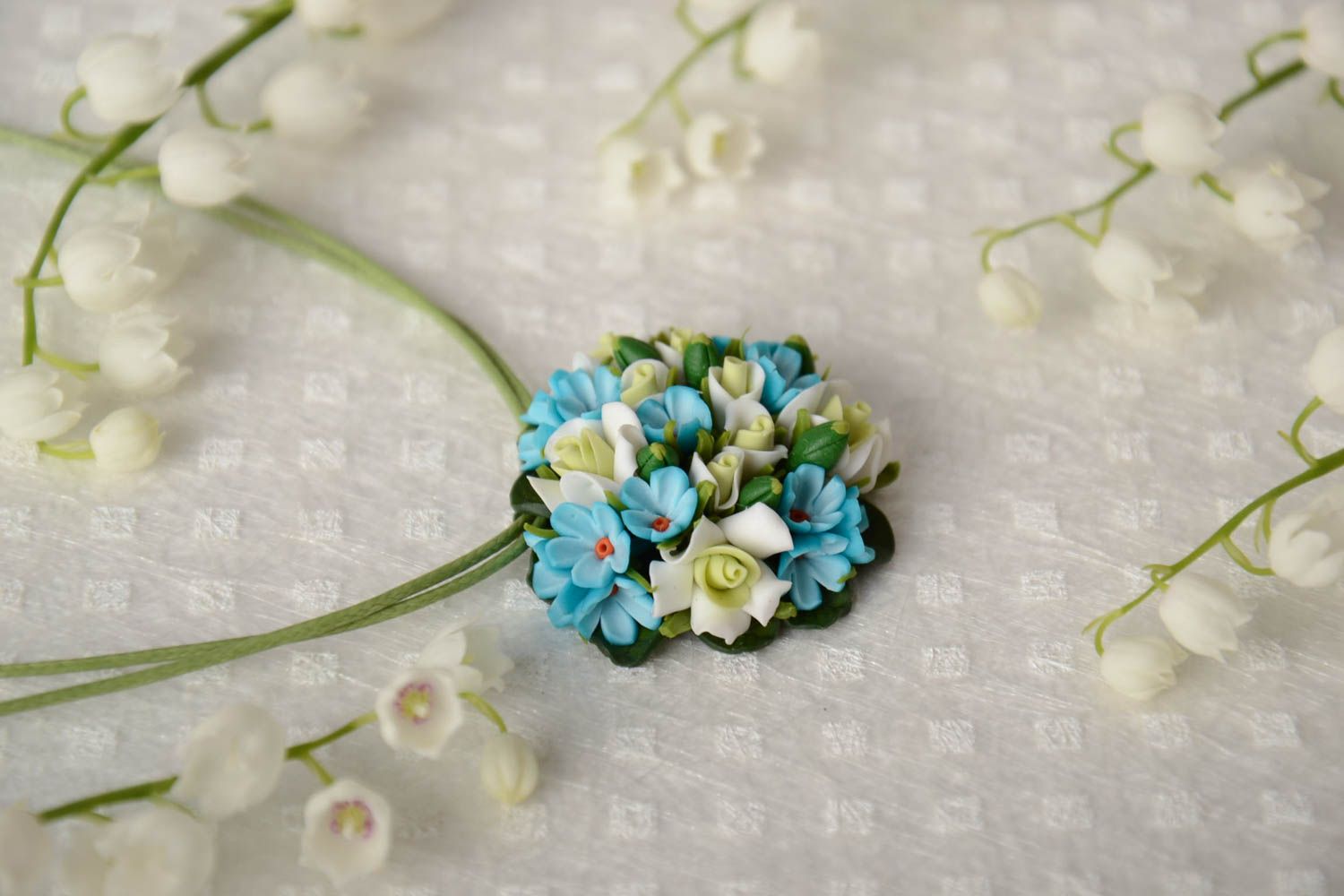 Handmade small round pendant necklace with blue polymer clay flowers on green cord photo 1