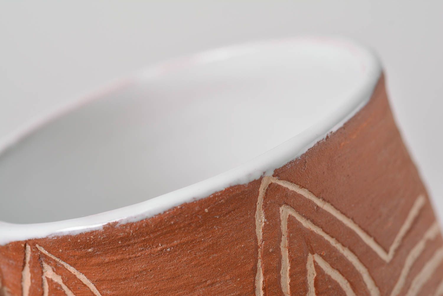 Rustic clay cup in white and brown color with handle and cave drawings photo 5