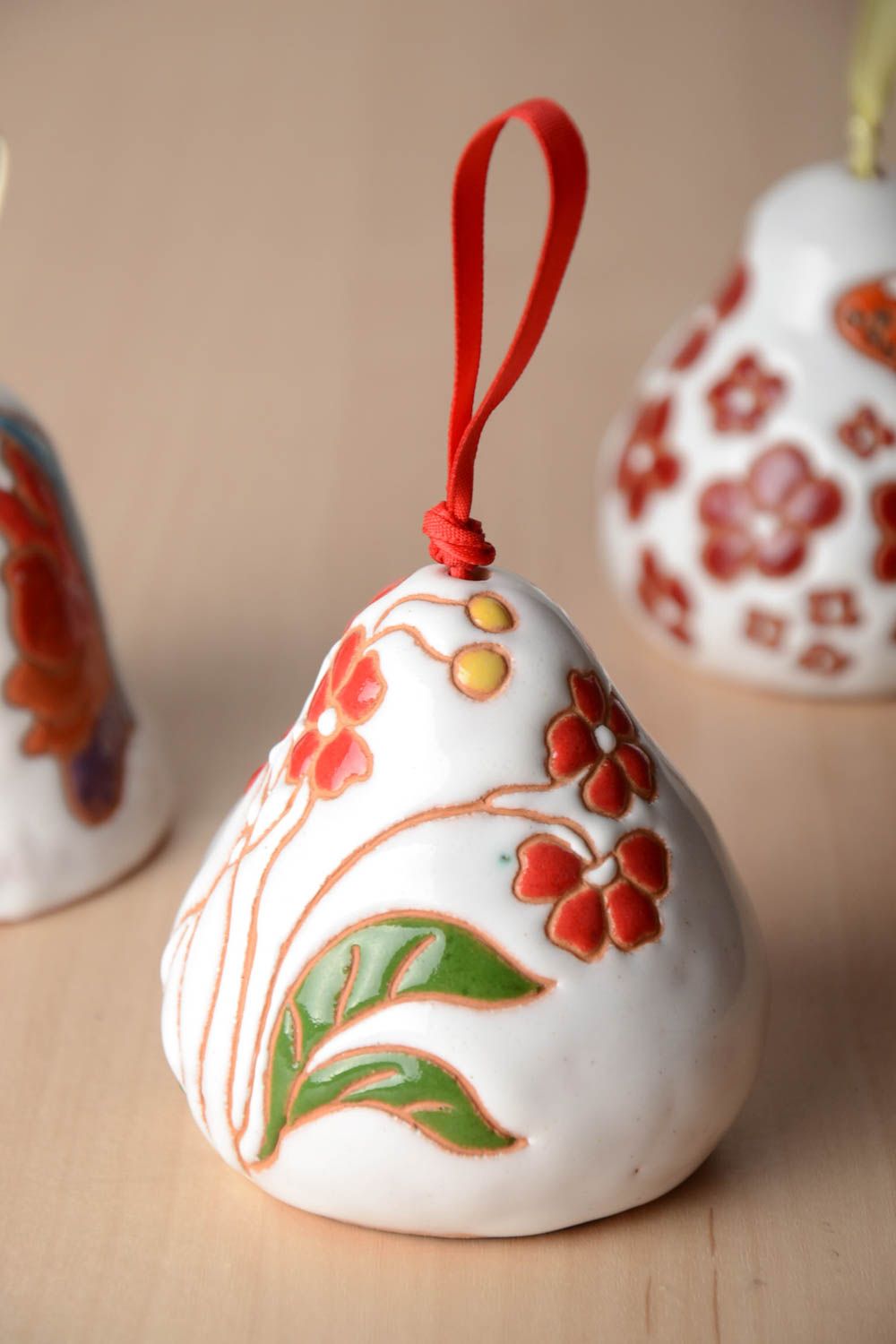 Handmade decorative pottery ceramic white bell with red flowers on red ribbon photo 1