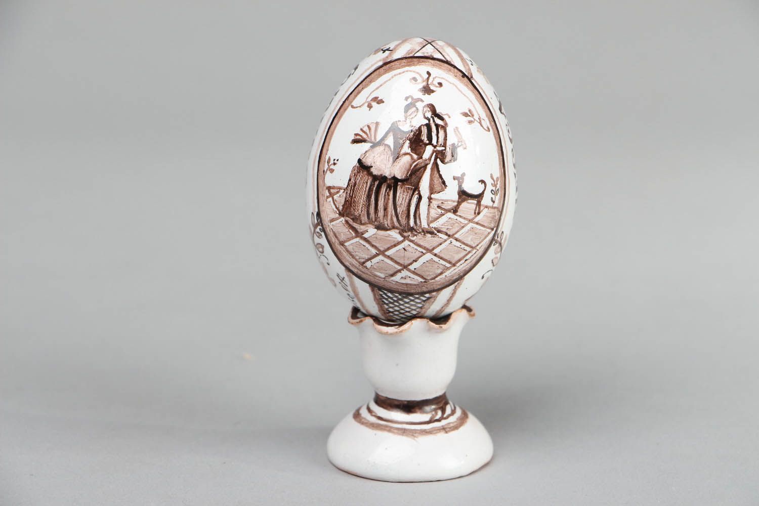 Ceramic egg on pedestal photo 1