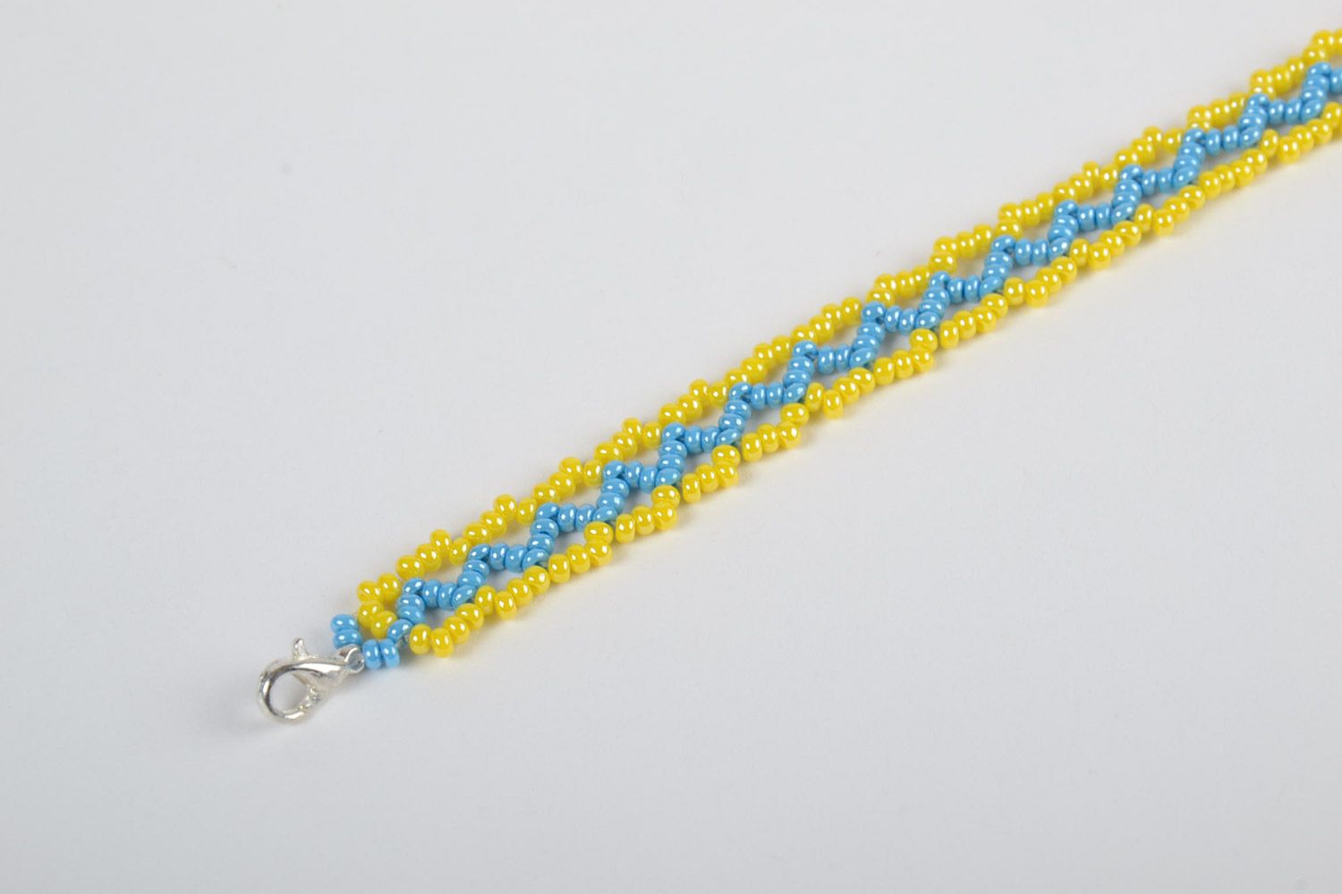 Beautiful bright handmade volume woven bead bracelet of yellow and blue colors photo 3