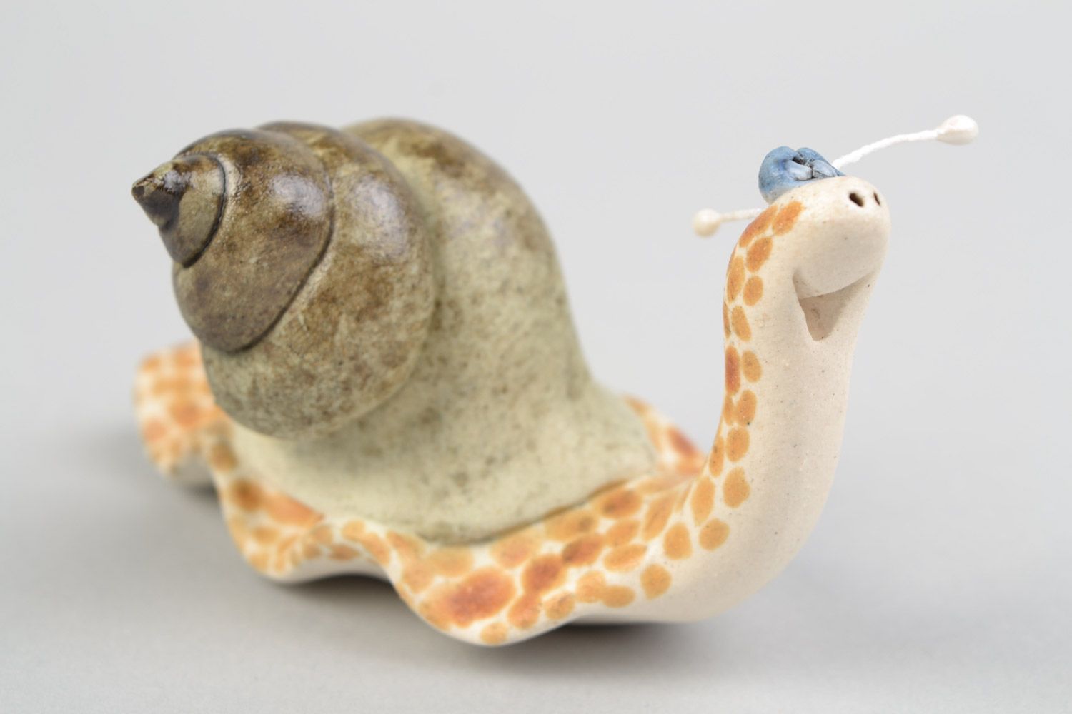 Handmade funny decorative ceramic figurine of smiling snail painted with glaze photo 1