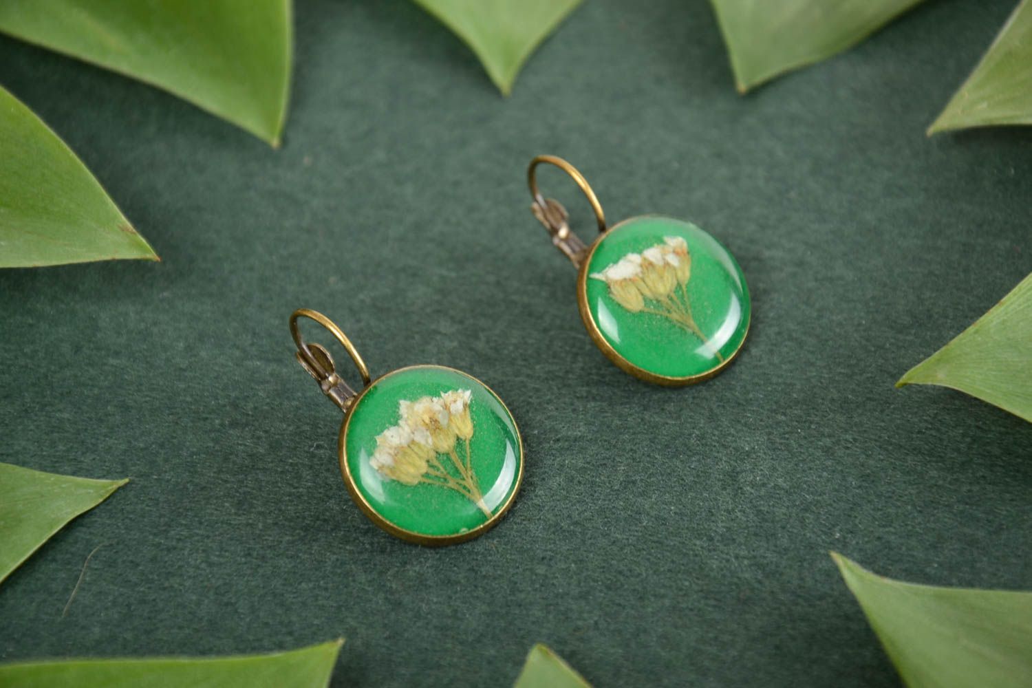 Homemade round green epoxy resin earrings with beautiful flowers inside photo 1