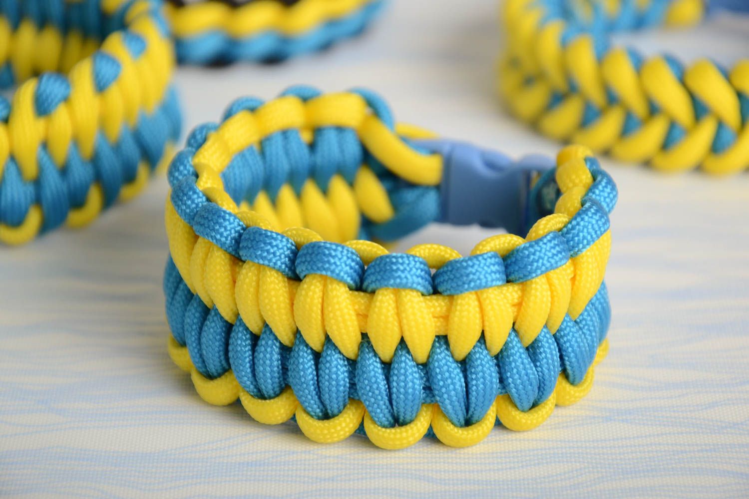 Handmade woven friendship bracelet made of paracord yellow with blue beautiful stylish accessory photo 1