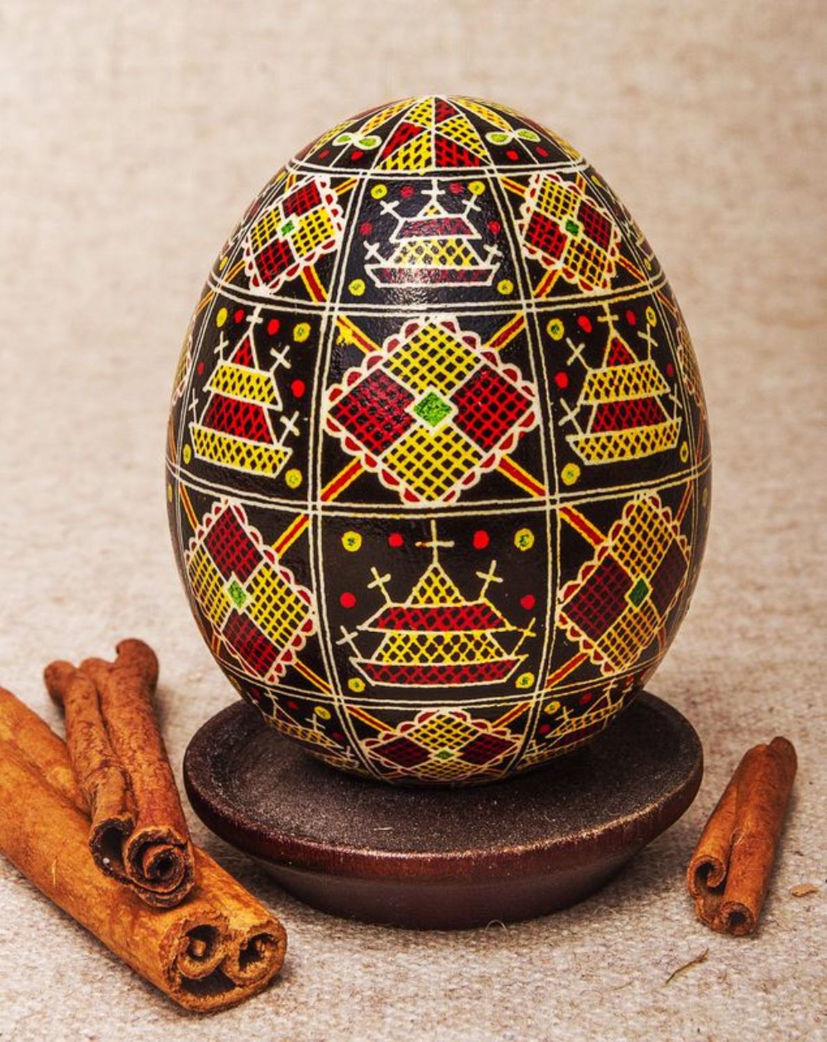Black pysanka with red and yellow ornament photo 1