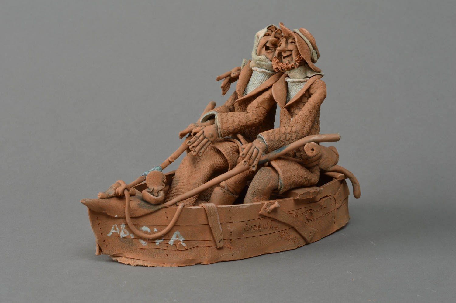 Handmade decorative unusual clay sculpture Cheerful couple in a boat photo 1
