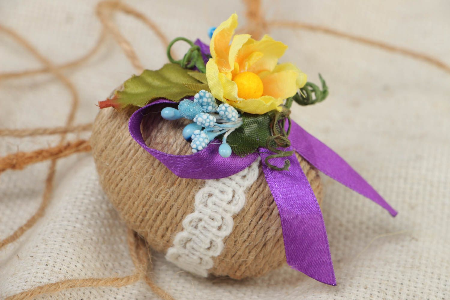 Wooden handmade Easter decorative egg wrapped with twine with flowers and lace photo 1