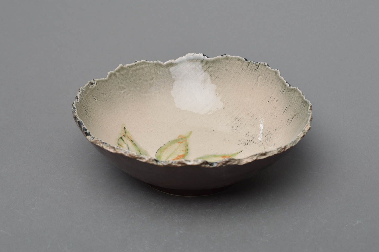 Handmade small designer porcelain bowl painted with glaze with leaves image photo 1