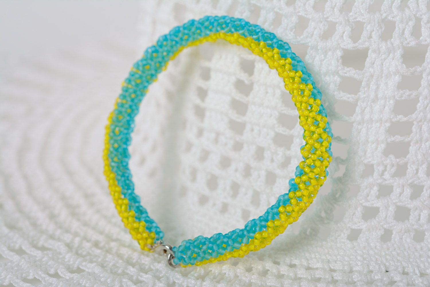 Thin handmade wrist bracelet woven of yellow and blue beads in Ukrainian style photo 1