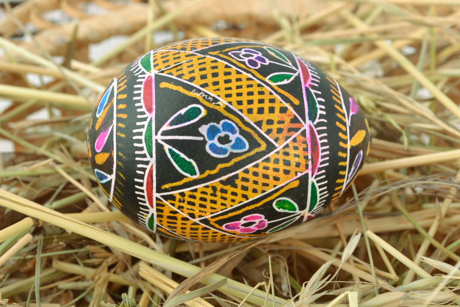 Handmade Easter egg with floral ornament painted with hot wax and aniline dyes photo 1