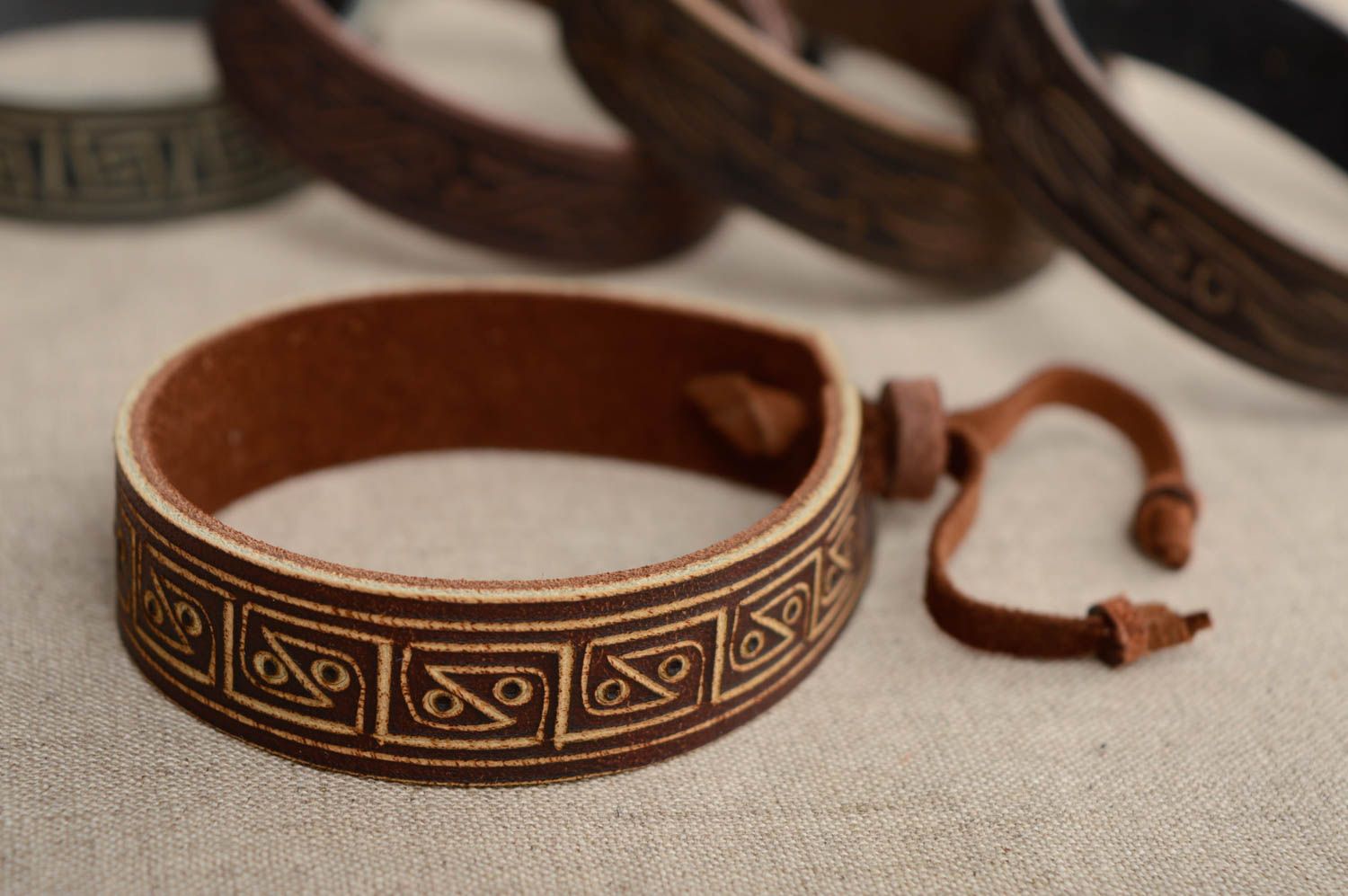 Carved leather bracelet with ties photo 2