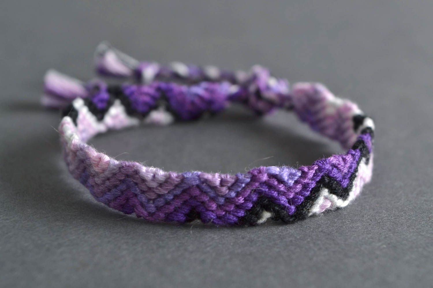 Handmade thin friendship wrist bracelet woven of threads in violet color shades photo 1