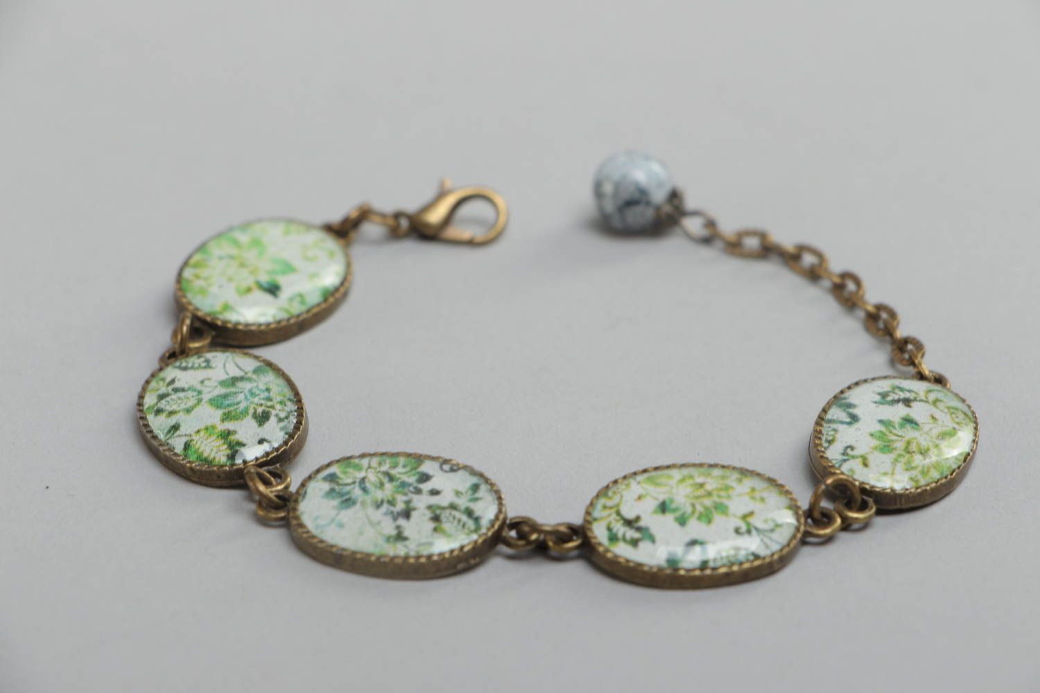 Handmade vintage bracelet made of glass glaze with metal fittings and pendants with green flowers photo 3