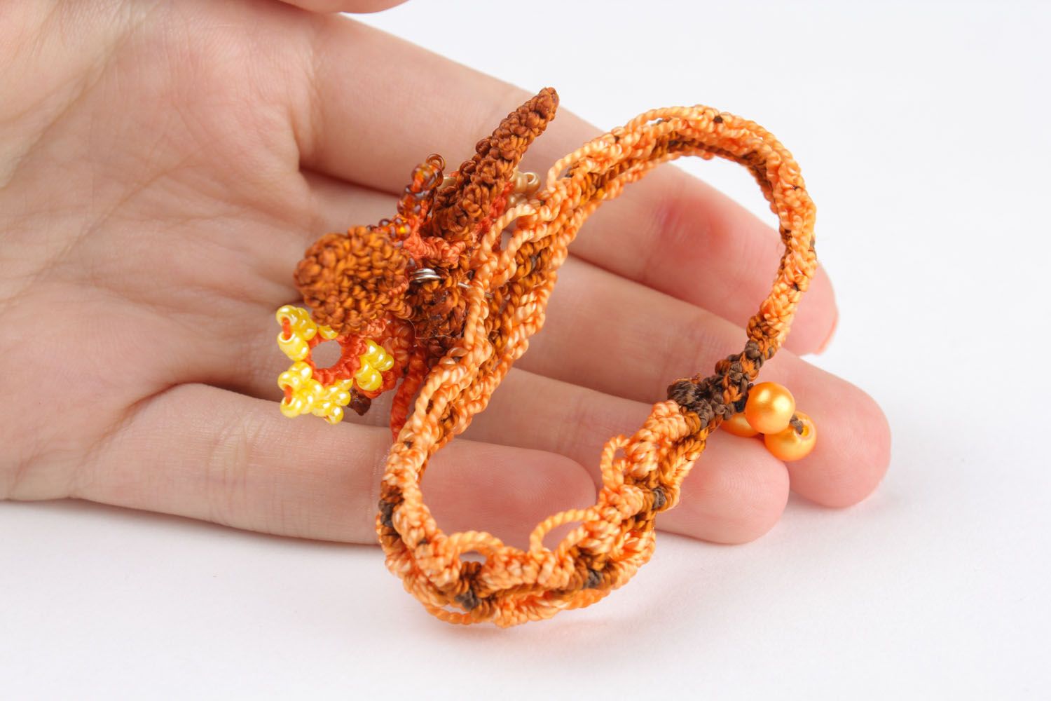 Bracelet made of threads and beads photo 2