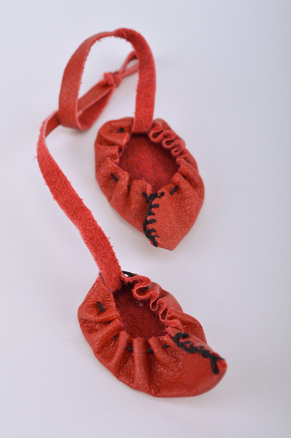 Handmade red leather keychain in the shape of bast shoes photo 2