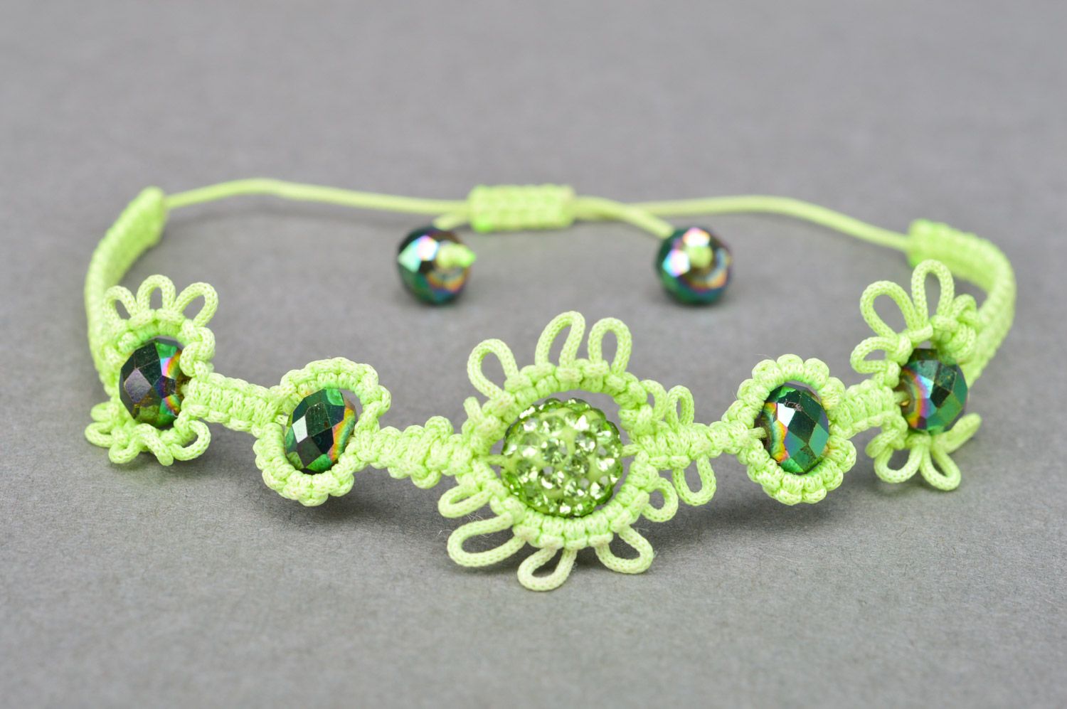 Stylish handmade women's wrist bracelet woven of threads and beads of lime color photo 2