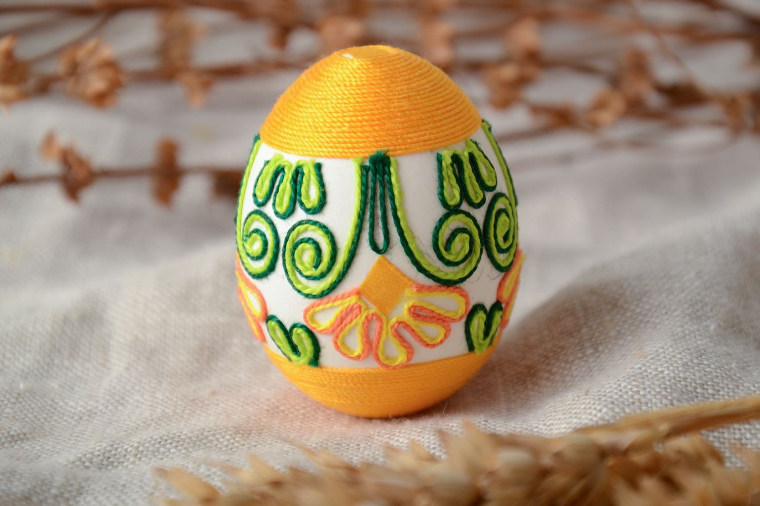Handmade Easter egg decorated with yellow threads photo 1
