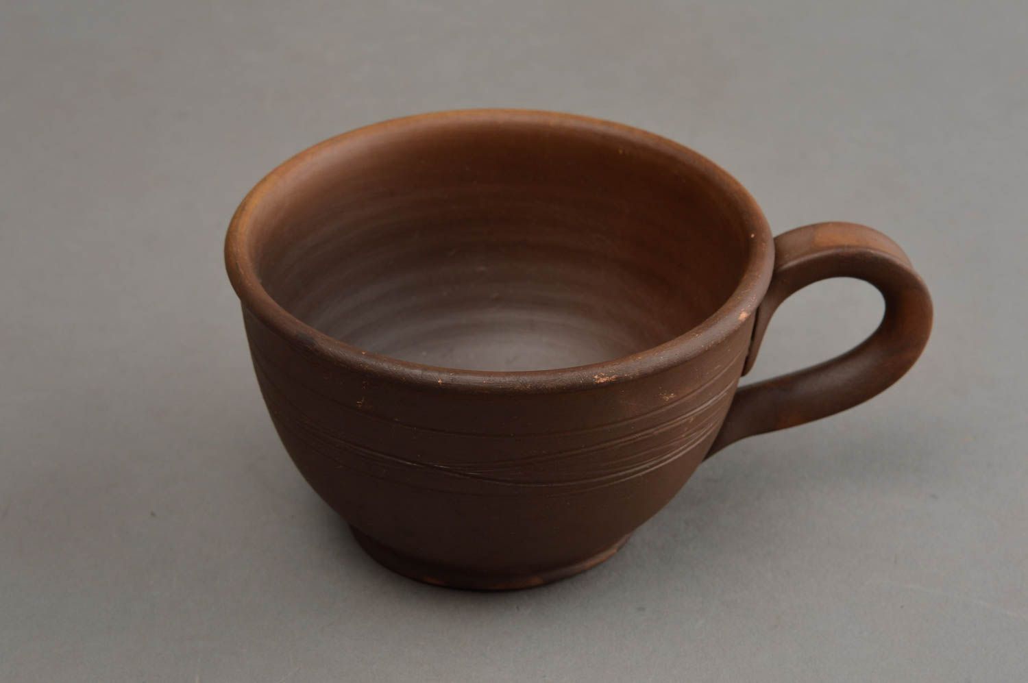 Brown wide ceramic wide coffee cup in rustic plain design with handle photo 3