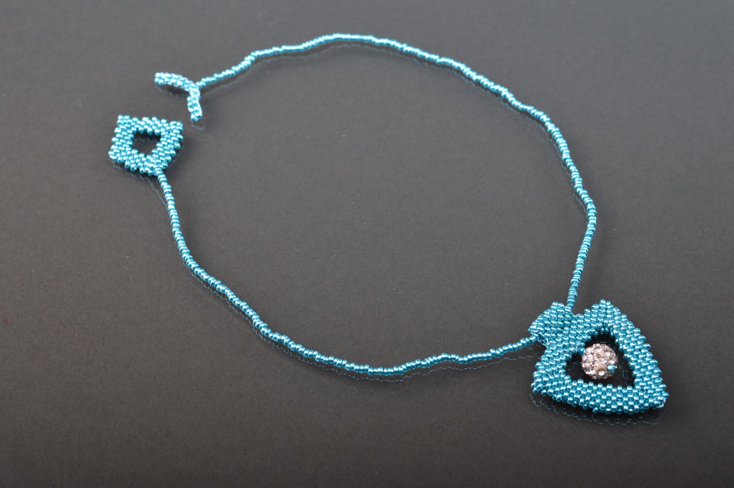 Handmade light blue triangle neck pendant woven of beads on cord with toggle lock photo 2