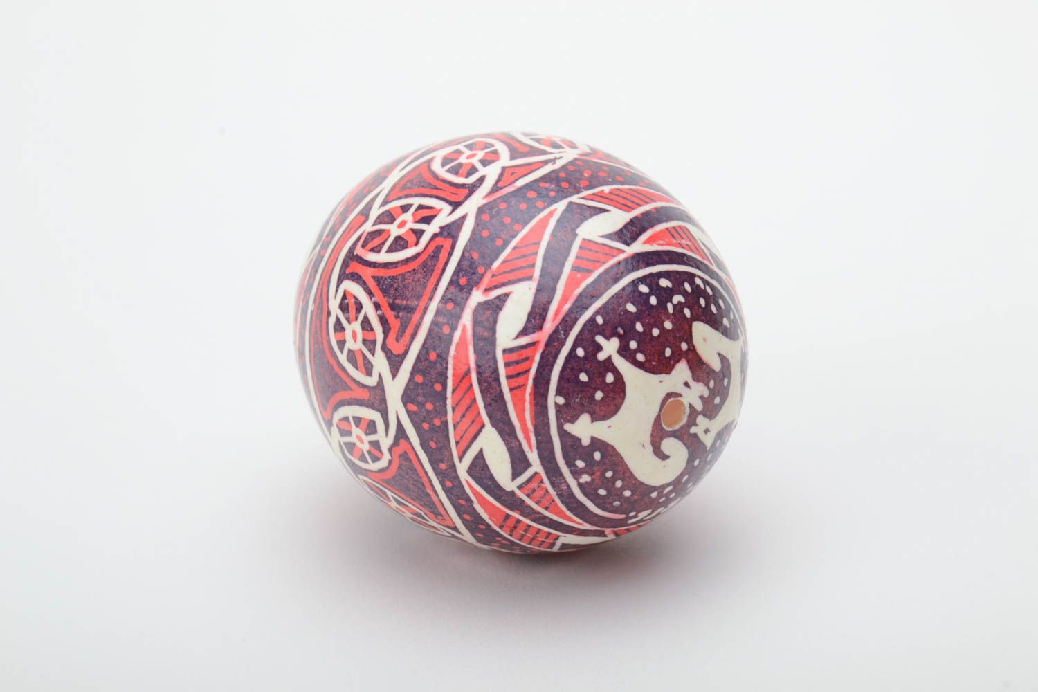 Homemade decorative ethnic painted Easter egg pysanka in red color palette photo 4