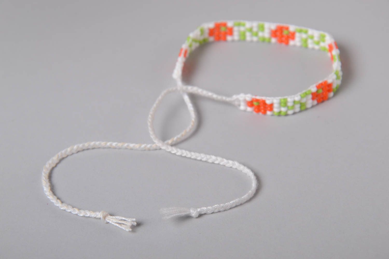 White rope thin line bracelet with red, white, and green beads photo 5