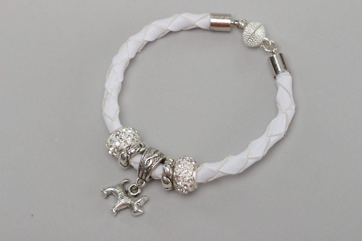 Handmade wrist bracelet woven of white faux leather with metal dog charm photo 4
