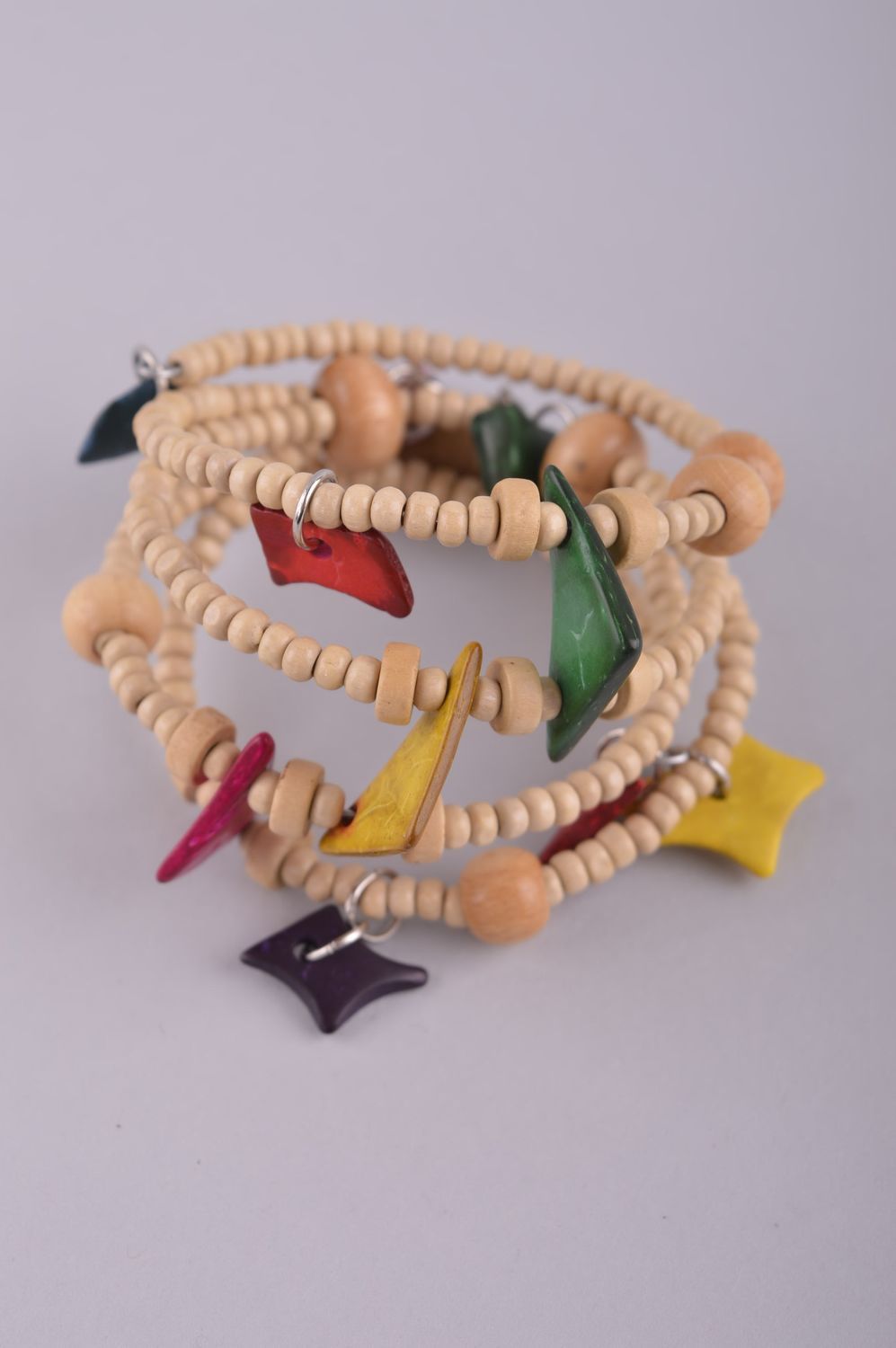 Wooden stretchy four-row beaded bracelet with the ball and geometric shape beads photo 2
