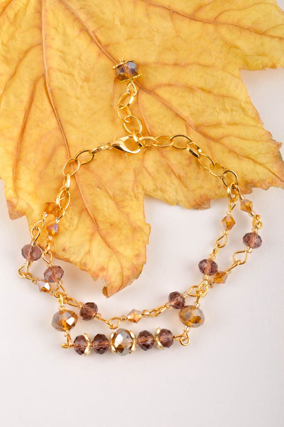 Chain bracelet in golden color with brown beads for girls photo 1