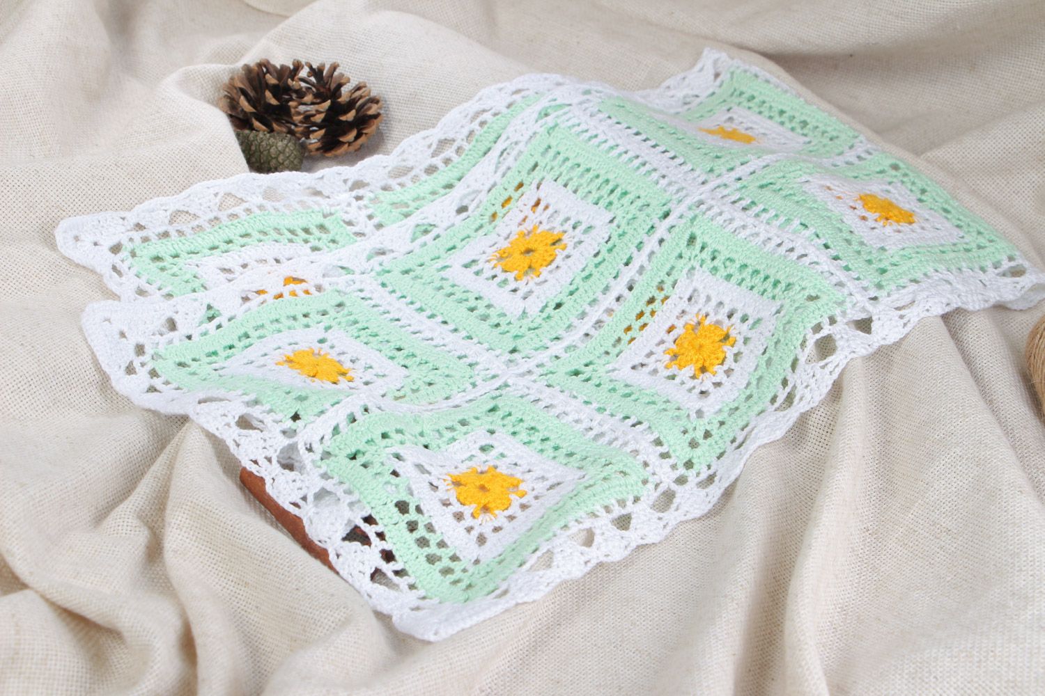 Handmade crocheted decorative napkin on the table made of cotton threads in light colors photo 1