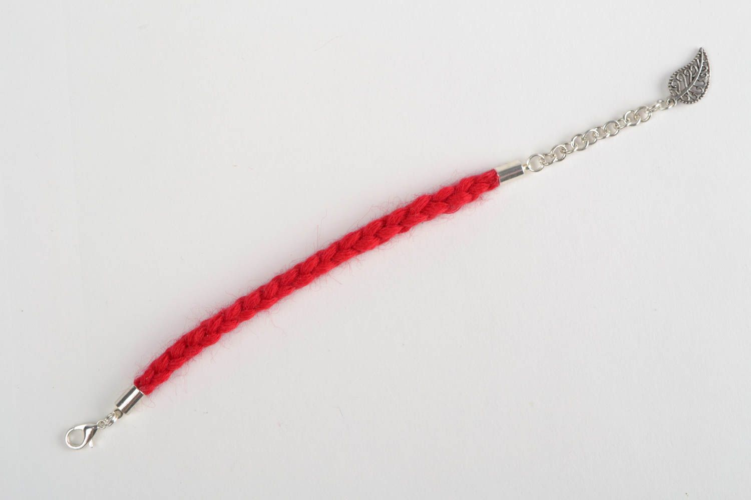 Handmade thin  wrist bracelet woven of red woolen threads with metal leaf charm  photo 5
