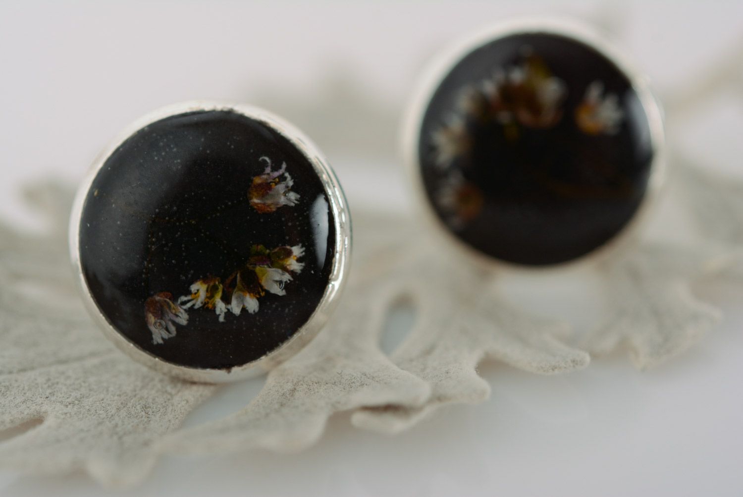 Homemade small black stud earrings with dried flower embedded in epoxy resin photo 1