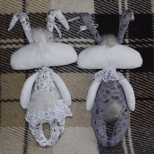 Pair of handmade soft toys sewn of fabric in the shape of rabbits for Easter photo 1