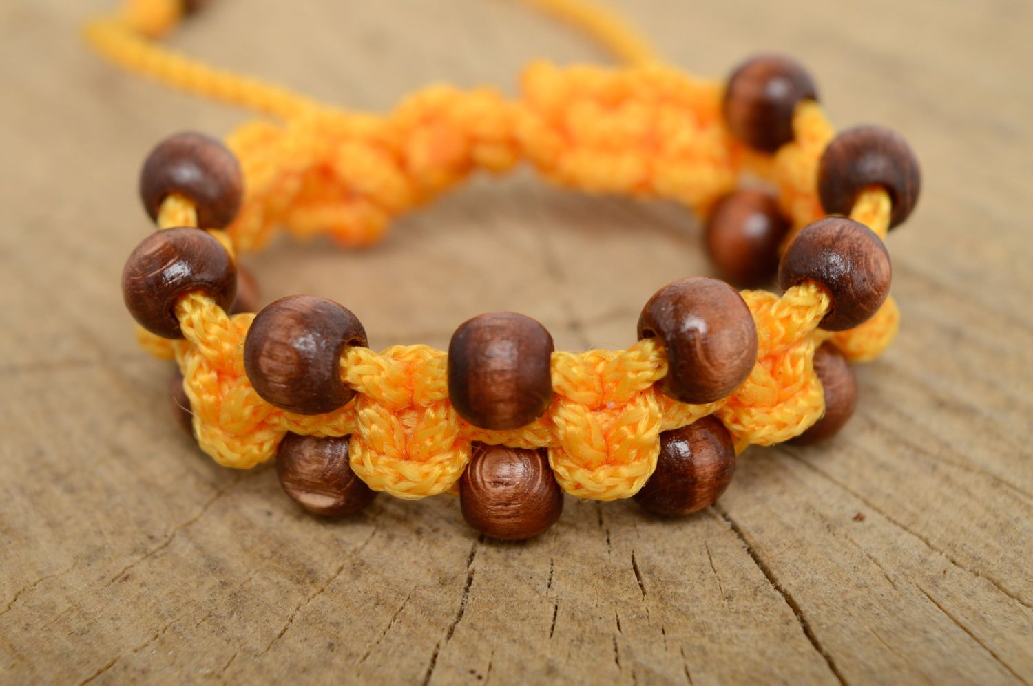 Macrame polyester cord bracelet of yellow color with wooden beads photo 1
