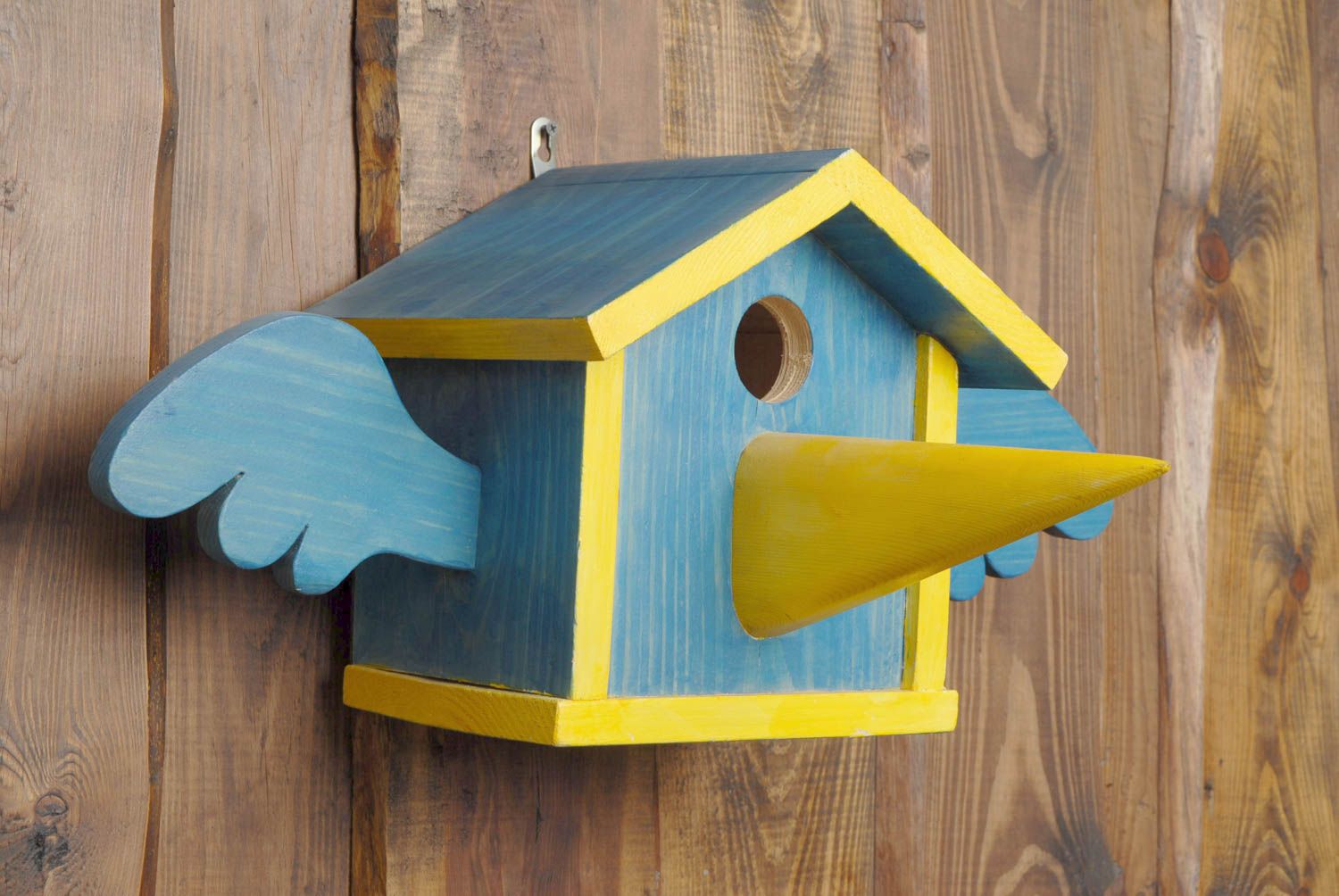 Painted wooden birdhouse with nose photo 1