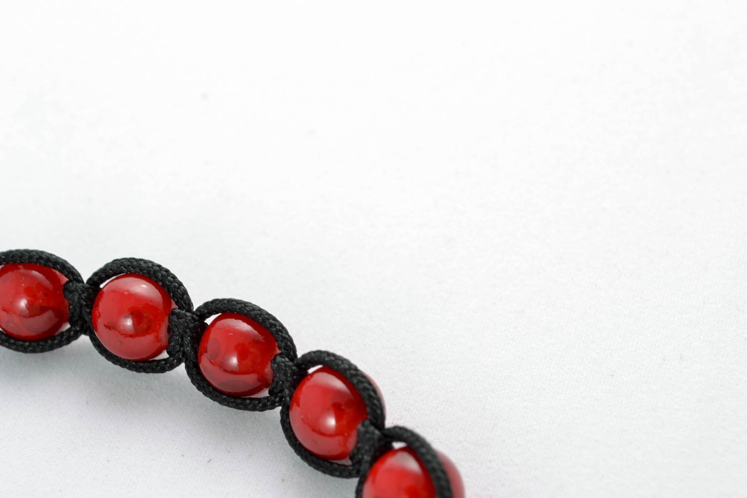 Cord bracelet with red beads photo 4