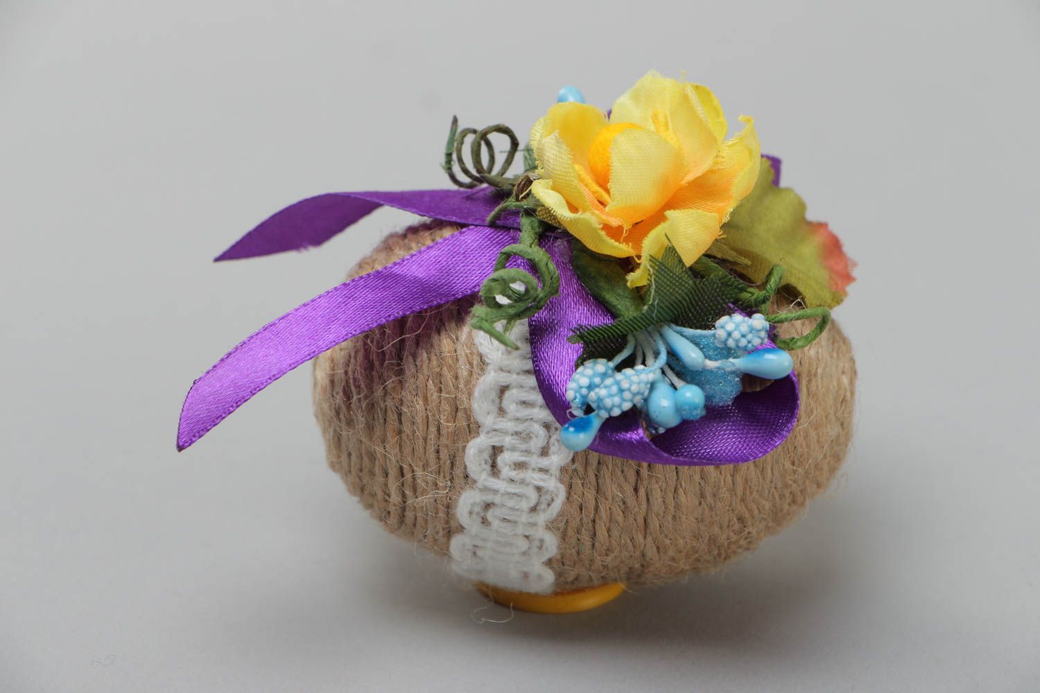 Wooden handmade Easter decorative egg wrapped with twine with flowers and lace photo 4