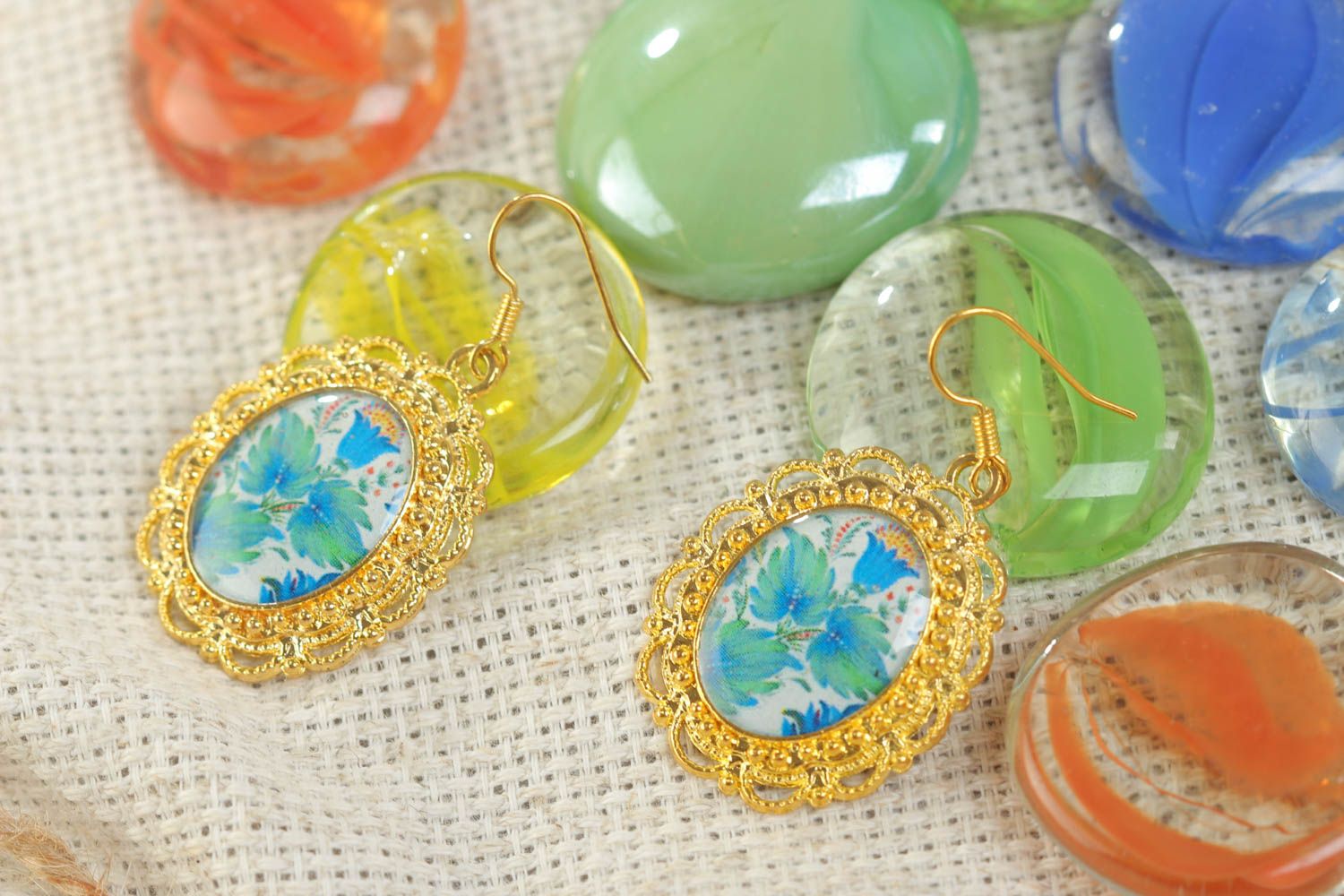 Handmade oval floral earrings with golden colored metal basis and glass glaze photo 1