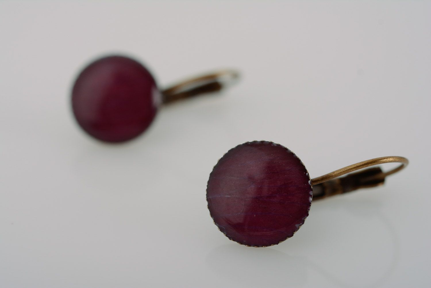 Handmade small dark round earrings with flower petals coated with epoxy resin photo 2